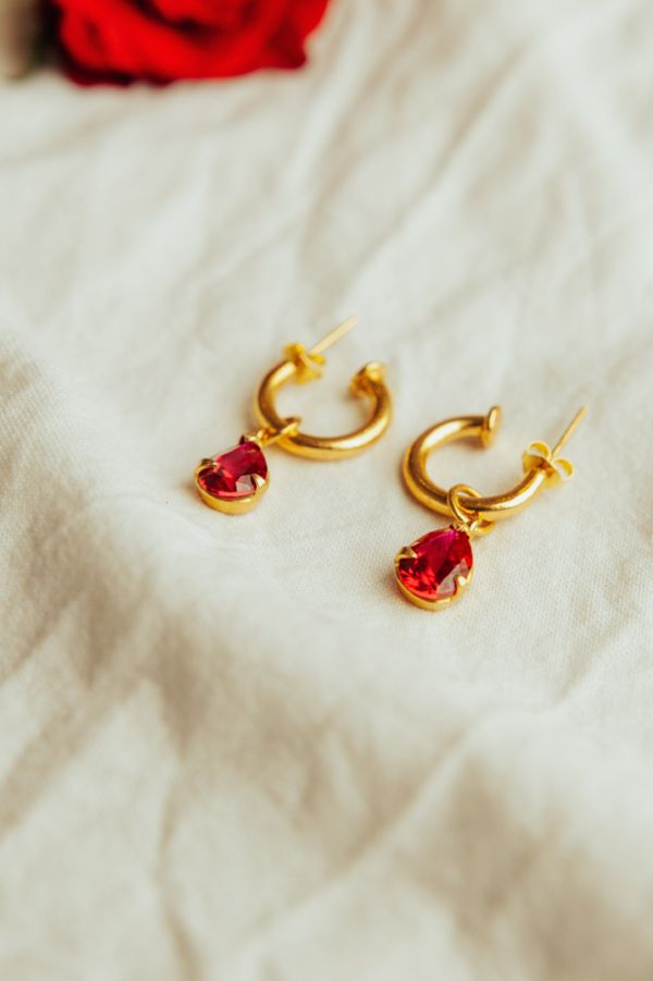 Image of women's golden earrings with ruby - a timeless and elegant accessory, featuring radiant gold and captivating ruby stones for a sophisticated and luxurious look.